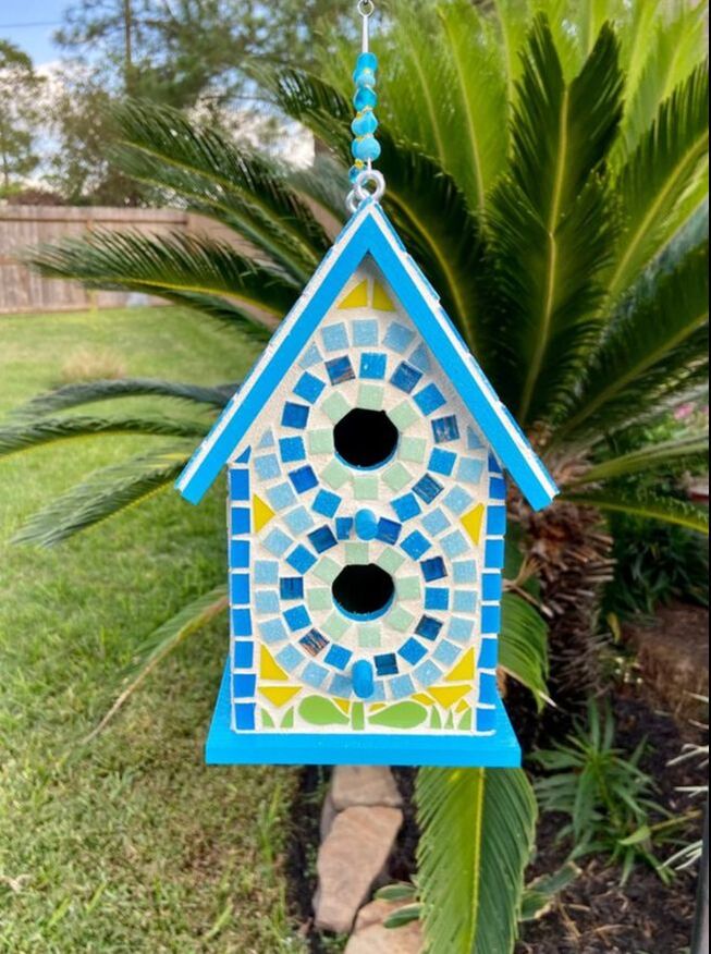 bright blue and yellow mosaic birdhouse